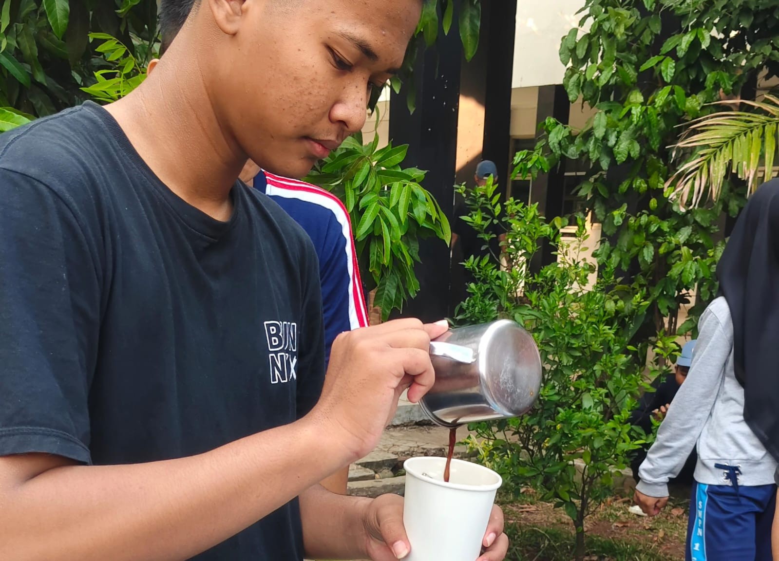 Student brewing coffee